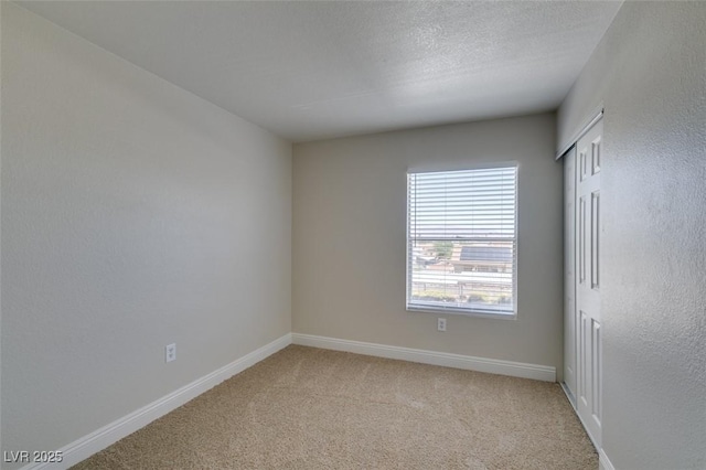 6800 E Lake Mead Blvd Unit 2072, Las Vegas, NV 89156 - spare room featuring light carpet and a textured ceiling