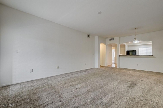 6160 Rumrill St Unit 202, Las Vegas, NV 89113 - unfurnished living room with arched walkways and light carpet
