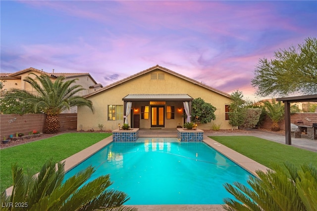 9685 Stonily Ln, Las Vegas, NV 89178 - back of property with stucco siding, a patio, and a fenced backyard