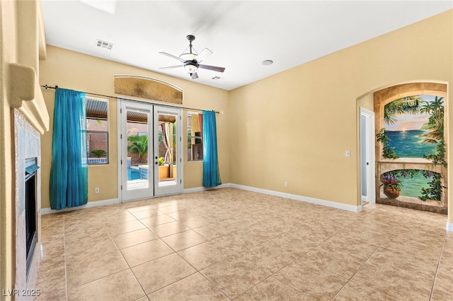 9685 Stonily Ln, Las Vegas, NV 89178 - unfurnished room featuring a ceiling fan, tile patterned floors, french doors, and a fireplace