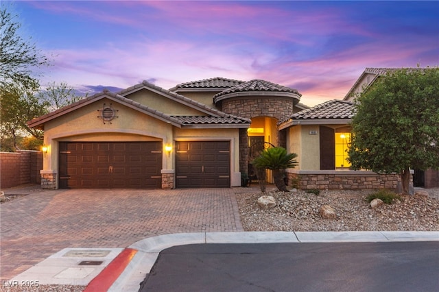 9685 Stonily Ln, Las Vegas, NV 89178 - mediterranean / spanish house featuring stone siding, a garage, and stucco siding