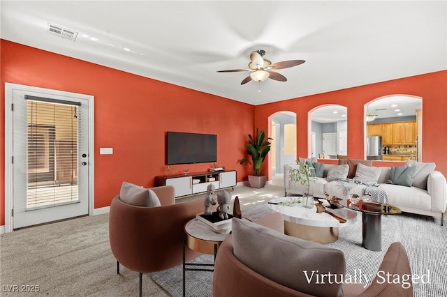 9685 Stonily Ln, Las Vegas, NV 89178 - carpeted living area featuring arched walkways and a ceiling fan