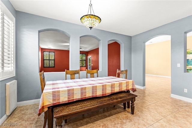 9685 Stonily Ln, Las Vegas, NV 89178 - dining space featuring light tile patterned floors and arched walkways