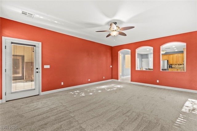 9685 Stonily Ln, Las Vegas, NV 89178 - carpeted spare room with a ceiling fan and arched walkways