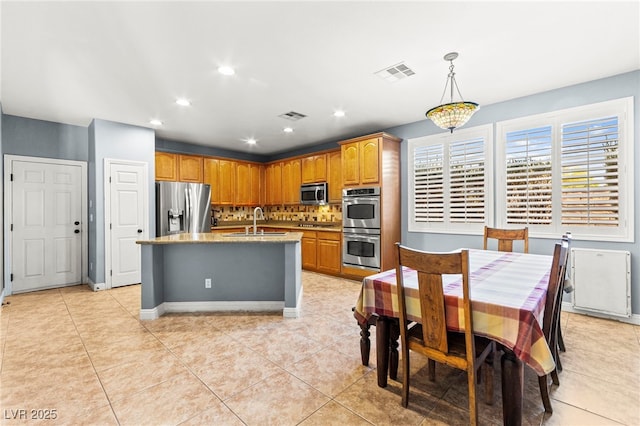 9685 Stonily Ln, Las Vegas, NV 89178 - kitchen featuring appliances with stainless steel finishes, tasteful backsplash, recessed lighting, a center island with sink, and light tile patterned flooring