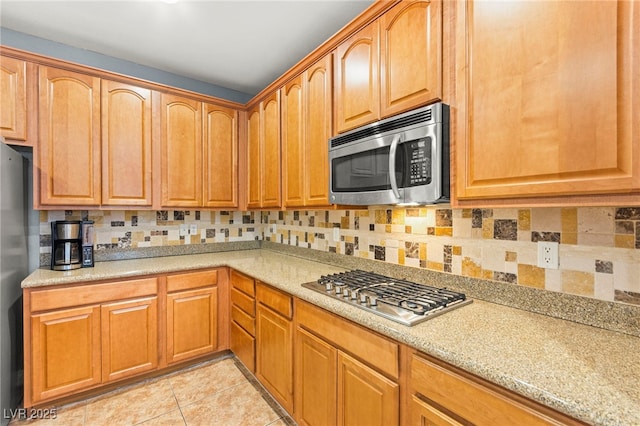 9685 Stonily Ln, Las Vegas, NV 89178 - kitchen with stainless steel appliances, light tile patterned floors, and backsplash
