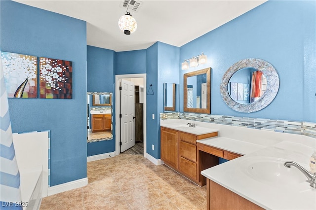 9685 Stonily Ln, Las Vegas, NV 89178 - bathroom featuring two vanities, a bath, backsplash, and tile patterned floors