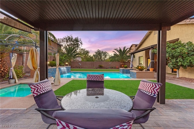 9685 Stonily Ln, Las Vegas, NV 89178 - patio terrace at dusk featuring a patio, a fenced backyard, and outdoor dining area