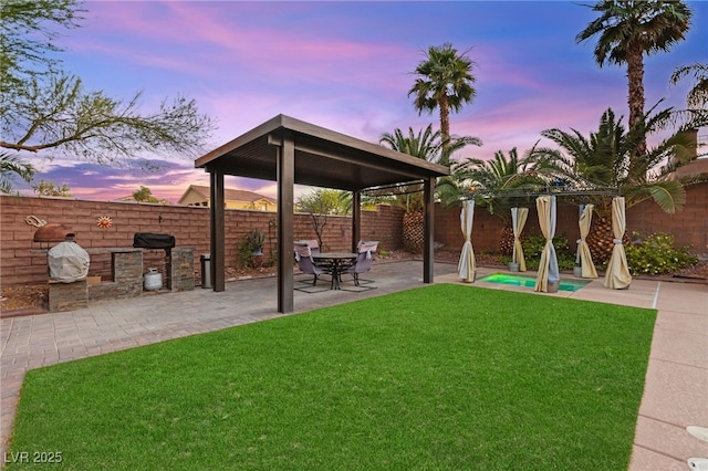 9685 Stonily Ln, Las Vegas, NV 89178 - yard at dusk featuring a gazebo, a fenced backyard, and a patio area