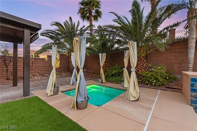 9685 Stonily Ln, Las Vegas, NV 89178 - pool at dusk with a fenced backyard and a patio