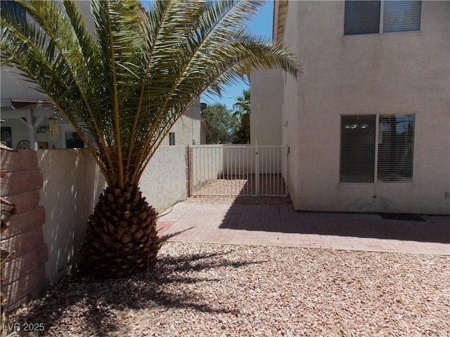 1018 Sun Poppy Ave, Las Vegas, NV 89123 - view of property exterior with stucco siding and a gate