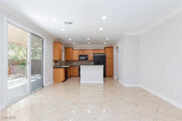 9814 Gifthouse St, Las Vegas, NV 89178 - kitchen with black appliances, dark countertops, backsplash, crown molding, and recessed lighting
