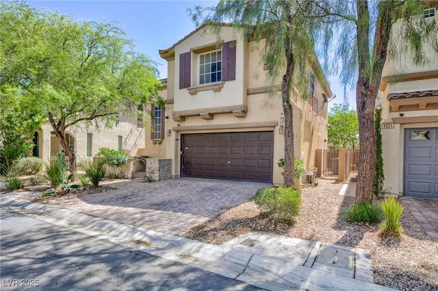 9814 Gifthouse St, Las Vegas, NV 89178 - view of front of property featuring stucco siding, an attached garage, and decorative driveway