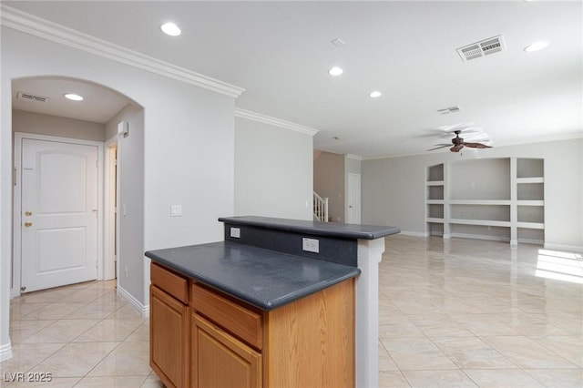 9814 Gifthouse St, Las Vegas, NV 89178 - kitchen with dark countertops, ornamental molding, arched walkways, ceiling fan, and built in features