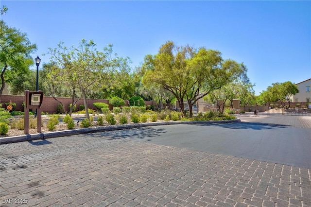 9814 Gifthouse St, Las Vegas, NV 89178 - view of street with curbs, a gate, street lighting, and a gated entry