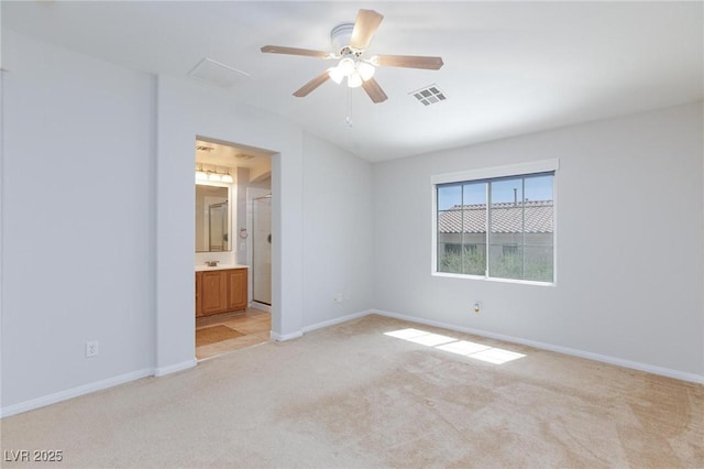 9814 Gifthouse St, Las Vegas, NV 89178 - unfurnished bedroom with light colored carpet, a ceiling fan, and connected bathroom