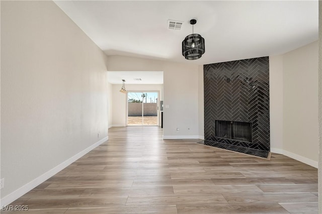 5004 Celebrity Cir, Las Vegas, NV 89119 - unfurnished living room featuring light wood-style flooring and a fireplace