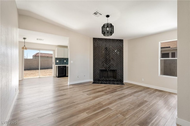5004 Celebrity Cir, Las Vegas, NV 89119 - unfurnished living room with light wood-type flooring and a fireplace