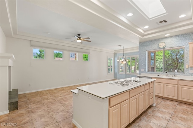10548 Findlay Ave, Las Vegas, NV 89134 - kitchen with white gas cooktop, a tray ceiling, light brown cabinets, light countertops, and recessed lighting