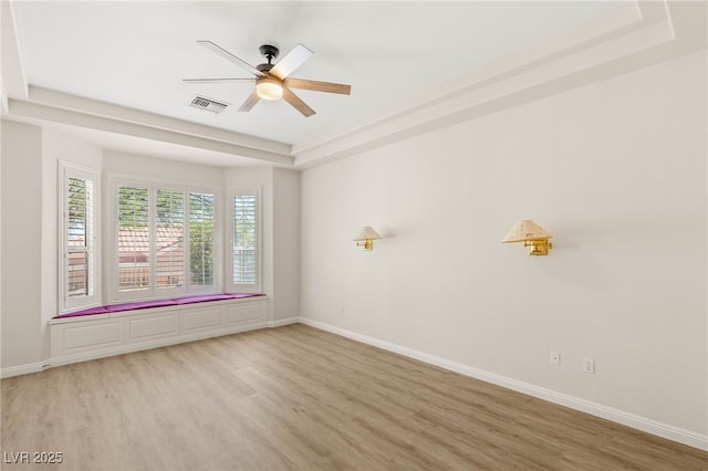 10548 Findlay Ave, Las Vegas, NV 89134 - empty room featuring a tray ceiling, light wood-style floors, and a ceiling fan