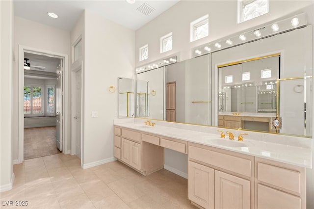 10548 Findlay Ave, Las Vegas, NV 89134 - bathroom featuring double vanity, a ceiling fan, tile patterned floors, and an enclosed shower
