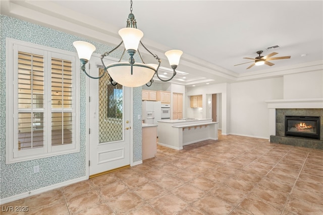 10548 Findlay Ave, Las Vegas, NV 89134 - kitchen with a raised ceiling, white appliances, light countertops, open floor plan, and ceiling fan