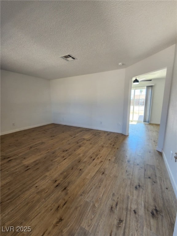 3318 Covey Ln, Las Vegas, NV 89115 - unfurnished room with a textured ceiling and wood finished floors