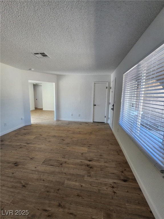 3318 Covey Ln, Las Vegas, NV 89115 - unfurnished room featuring wood finished floors and a textured ceiling