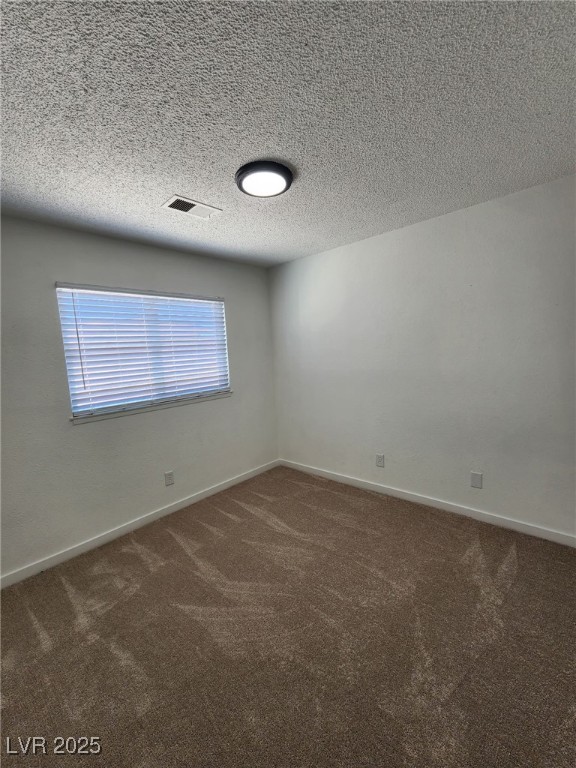 3318 Covey Ln, Las Vegas, NV 89115 - carpeted spare room featuring baseboards and a textured ceiling
