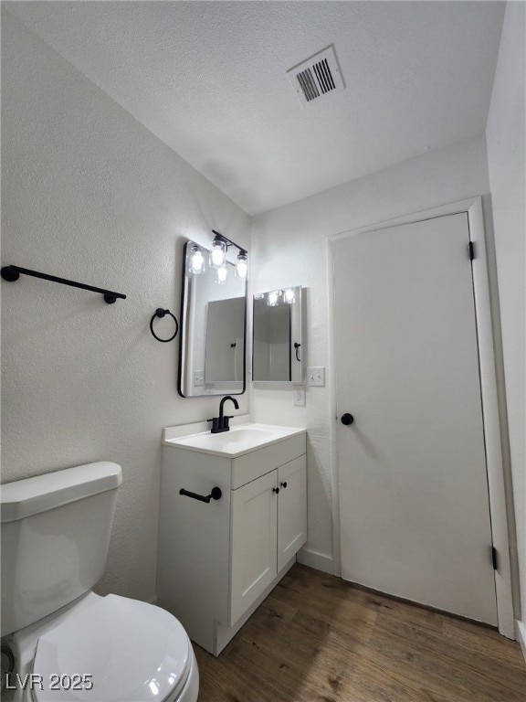 3318 Covey Ln, Las Vegas, NV 89115 - bathroom with vanity, wood finished floors, and a textured wall