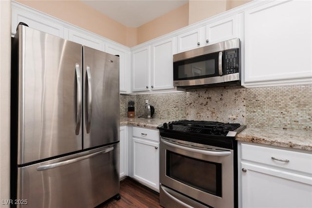1839 Thunder Mountain Dr, Henderson, NV 89012 - kitchen featuring stainless steel appliances, white cabinetry, tasteful backsplash, and light stone countertops