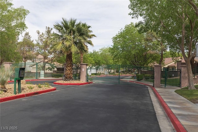 1839 Thunder Mountain Dr, Henderson, NV 89012 - view of asphalt road featuring a gate, curbs, a gated entry, and sidewalks