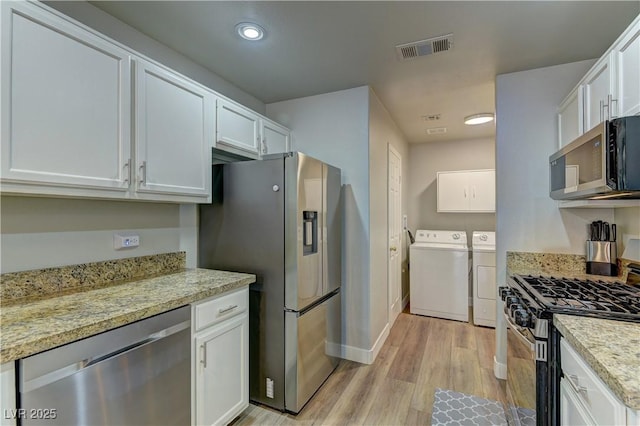 278 Star Cluster Cir, Las Vegas, NV 89145 - kitchen with stainless steel appliances, washer and clothes dryer, white cabinetry, light wood-style flooring, and recessed lighting
