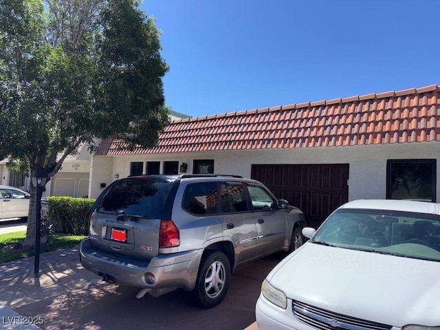 3447 One Nation Ave, Las Vegas, NV 89121 - view of front of home with a tile roof, a garage, and stucco siding