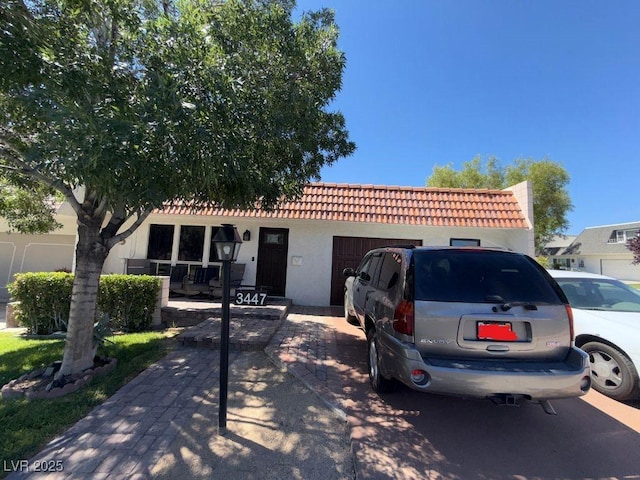3447 One Nation Ave, Las Vegas, NV 89121 - view of front of home with a tile roof, stucco siding, and a porch