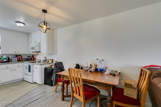 225 Pecos Way, Las Vegas, NV 89121 - kitchen with white appliances, white cabinets, light wood-style floors, and decorative light fixtures
