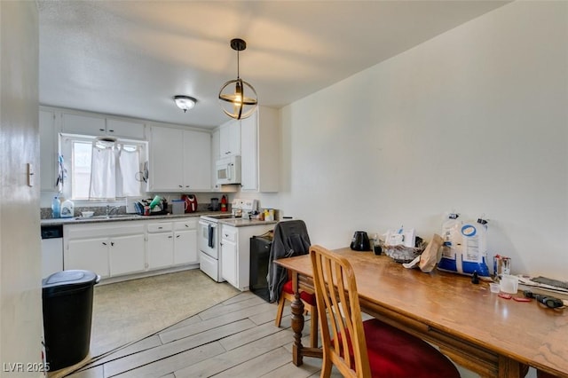 225 Pecos Way, Las Vegas, NV 89121 - kitchen featuring white appliances, white cabinets, light wood finished floors, and decorative light fixtures