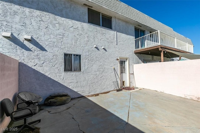 225 Pecos Way, Las Vegas, NV 89121 - back of property featuring stucco siding, a balcony, and a patio area