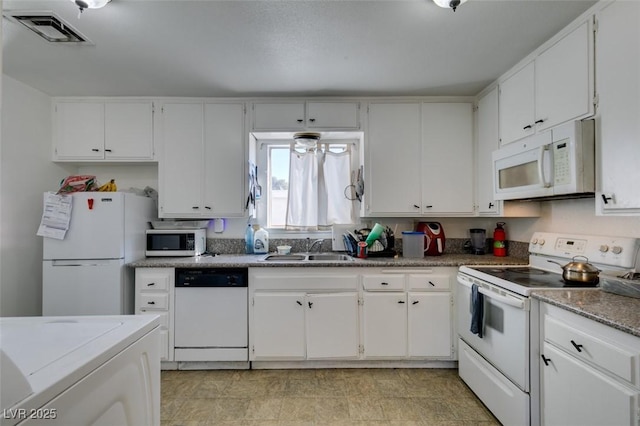 225 Pecos Way, Las Vegas, NV 89121 - kitchen with white appliances, white cabinetry, and washer / clothes dryer