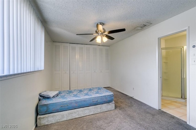 225 Pecos Way, Las Vegas, NV 89121 - carpeted bedroom featuring a textured ceiling, a ceiling fan, and ensuite bath