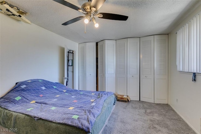 225 Pecos Way, Las Vegas, NV 89121 - carpeted bedroom featuring a textured ceiling, two closets, and ceiling fan
