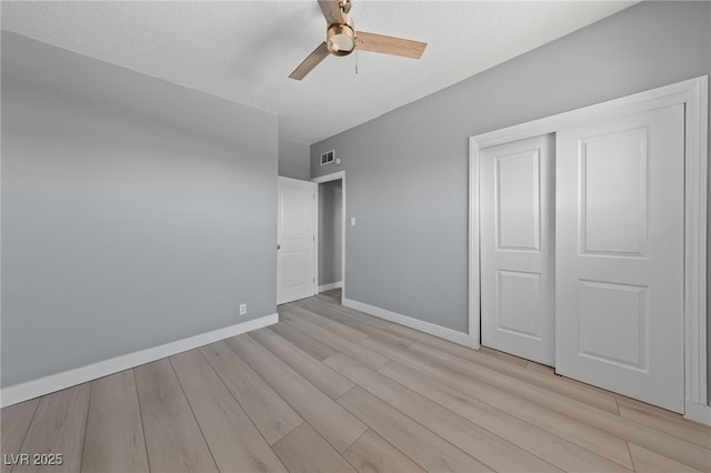 104 Stanford St, Las Vegas, NV 89107 - unfurnished bedroom with light wood-type flooring, a closet, ceiling fan, and a textured ceiling