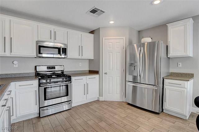554 Haunts Walk Ave, Las Vegas, NV 89178 - kitchen featuring stainless steel appliances, white cabinetry, light wood-style flooring, and recessed lighting