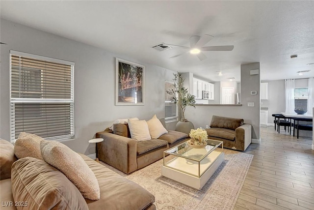 554 Haunts Walk Ave, Las Vegas, NV 89178 - living room featuring a ceiling fan and light wood-style flooring