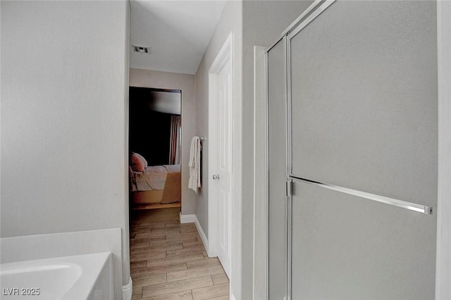 554 Haunts Walk Ave, Las Vegas, NV 89178 - ensuite bathroom featuring a shower stall, wood finished floors, and a garden tub