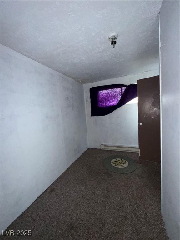 1104 High St, Ely, NV 89301 - hallway featuring a baseboard heating unit, carpet flooring, and a textured ceiling