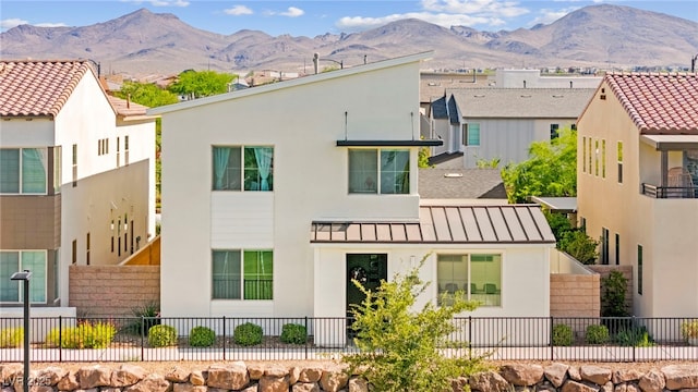 3058 Casarano Ct, Henderson, NV 89044 - back of house with stucco siding, a standing seam roof, and a mountain view