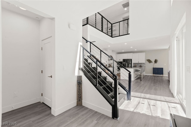 3058 Casarano Ct, Henderson, NV 89044 - staircase with wood finished floors, a high ceiling, and recessed lighting