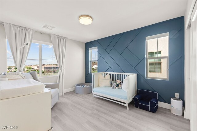 3058 Casarano Ct, Henderson, NV 89044 - bedroom featuring multiple windows and light wood-style floors