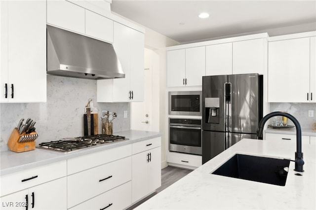 3058 Casarano Ct, Henderson, NV 89044 - kitchen with stainless steel appliances, extractor fan, decorative backsplash, white cabinets, and recessed lighting